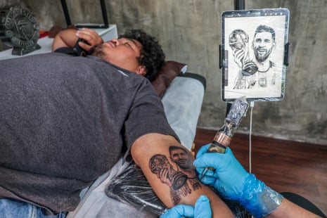 A tattoo artist in Bangkok, Thailand, doing World Cup designs.