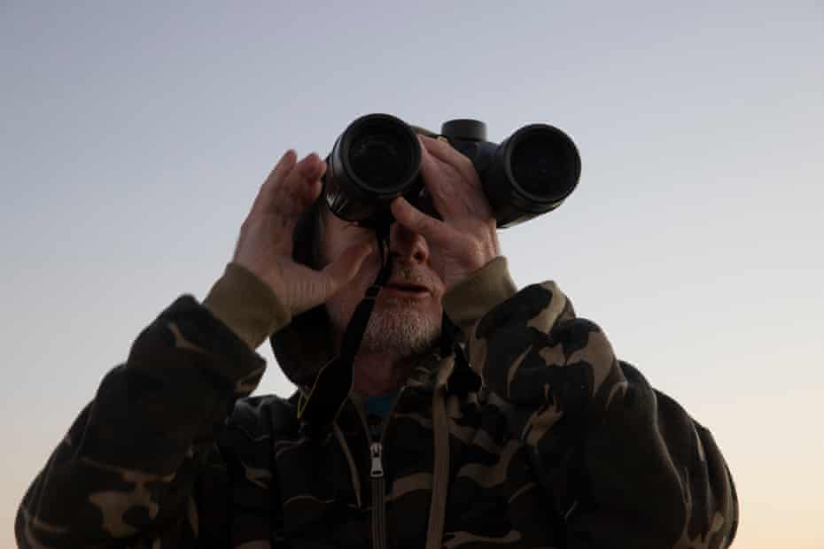 Veteran whale watching volunteer Wayne Reynolds scans the ocean.