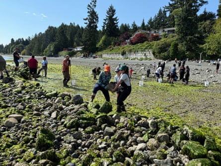 Women carrying a rock