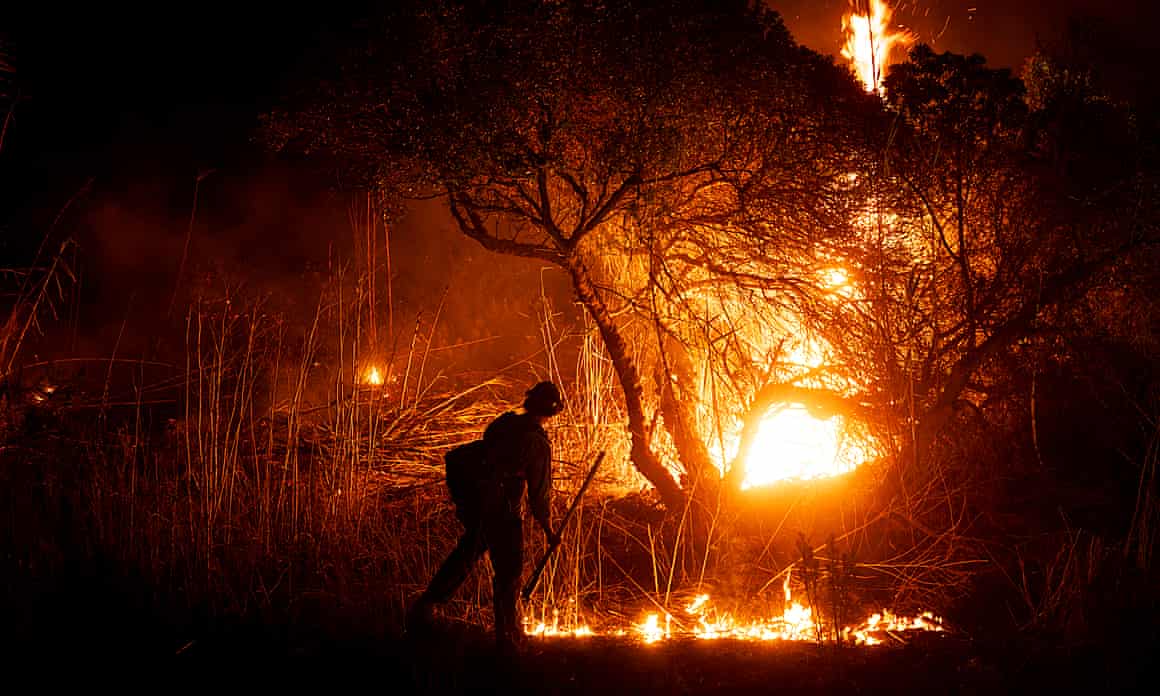 A firefighter monitors the spread of the Auto Fire in Oxnard, north-west of Los Angeles, California