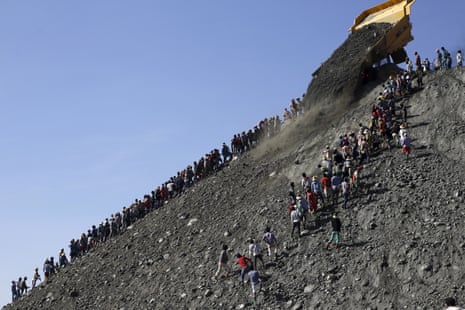 Miners search for jade stones at a mine dump at a Hpakant jade mine in Kachin state, Myanmar November 25, 2015