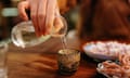 Pouring Japanese Sake<br>A close-up shot of a hand pouring sake in a tavern