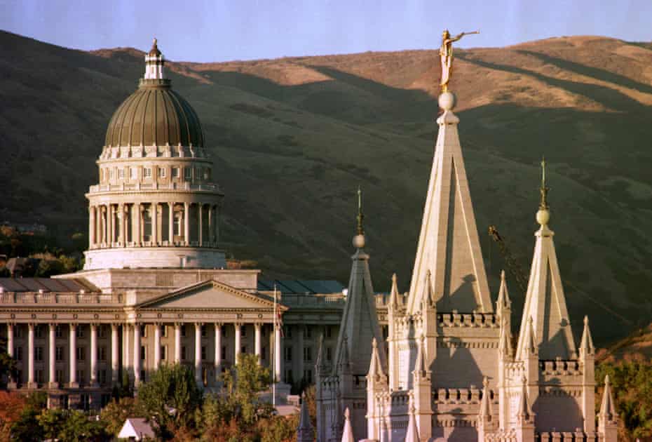 The sun sets on Utah’s Capitol, left, and the angel-topped spire of the Mormon Temple