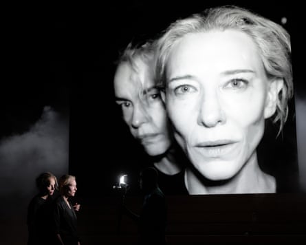 Nina Hoss and Cate Blanchett live in the lower left of frame and projected in large black and white behind