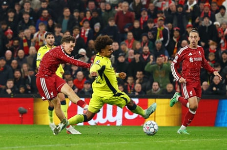 Florian Wirtz shoots past a sliding Villarreal defender to score during a Champions League match