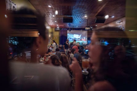 people standing inside of a bar
