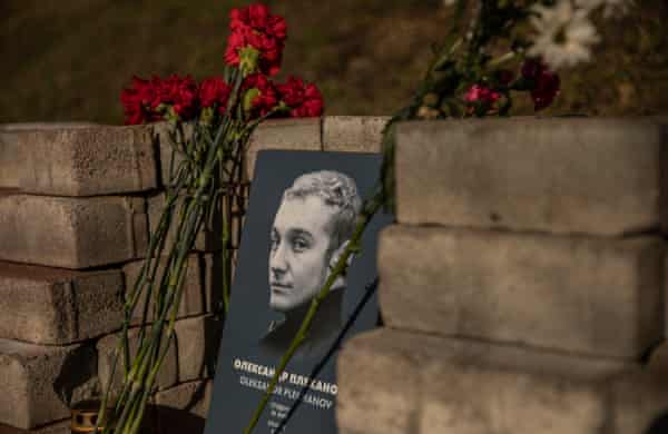 A memorial to ⁢Oleksandr Plekhanov, with flowers beside it