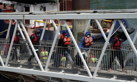 People picked up in the Channel are disembarked from a British border force vessel, in Dover.