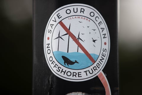 Anti-windfarm stickers  are seen on a pole above Thirroul beach in the Illawarra region of NSW. Some locals are claiming offshore turbines could disturb whales, despite evidence to the contrary. 
