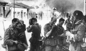 German troops in the burning ruins of Vitebsk, now in north-east Belarus, in August 1941.