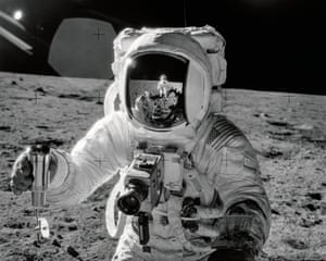 apollo 12 lunar module pilot alan bean on the surface of the moon holding a special environment sample container