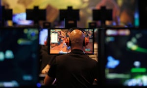 A visitor plays World of Warcraft: Warlords of Draenor at an entertainment exhibition in Cologne, Germany.