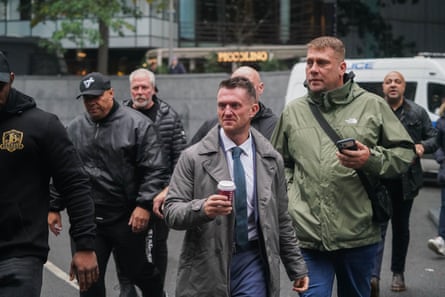 Tommy Robinson with his entourage of other men on his way into court