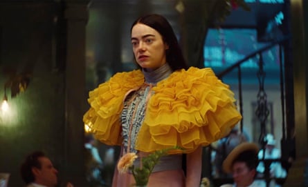 Emma Stone in Poor Things wearing yellow ruffled shawl