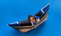A paper boat showing Rishi Sunak's face and the message 'Stop the boats' against a blue background. Credit: Guardian Design Team/PA