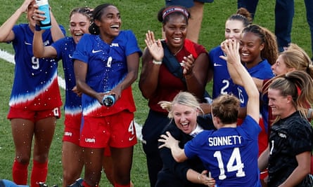 Emma Hayes celebrates winning Olympic gold with her USA players in Paris.