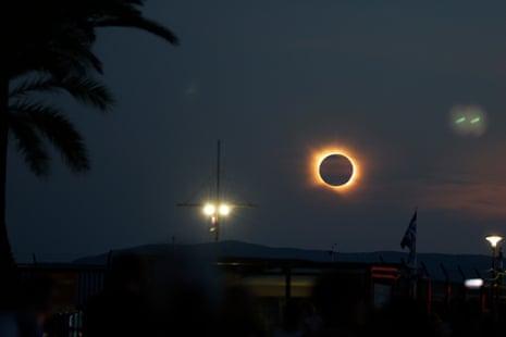 The Sun’s corona glows as the Moon completely blocks the Sun during the totality phase of the total solar eclipse as seen from Arenal beach in Llucmajor, on the Balearic island of Mallorca