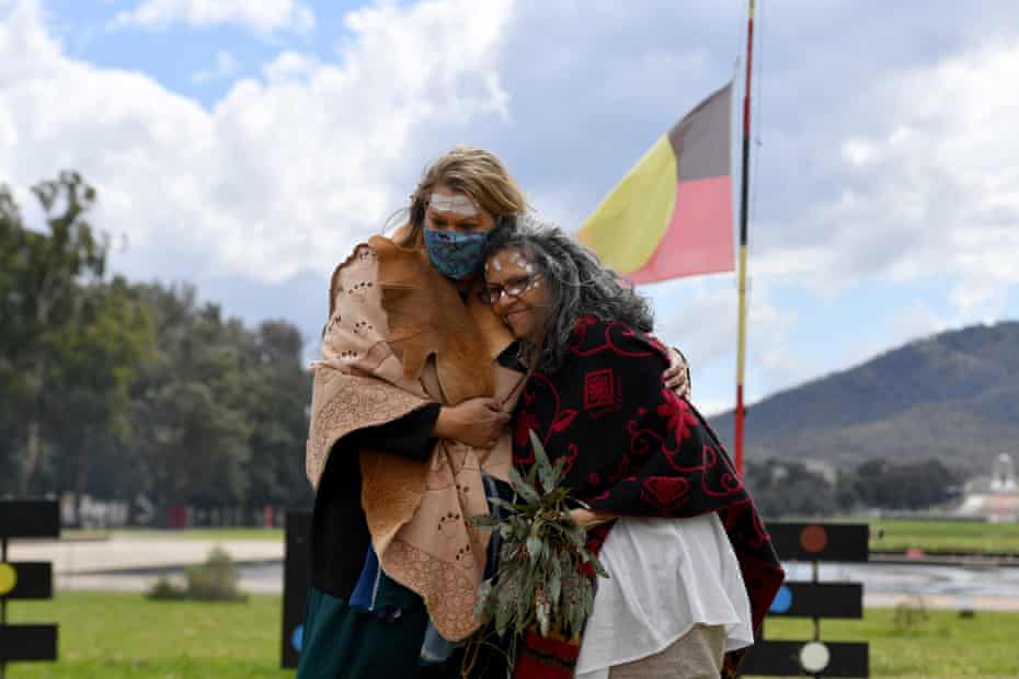 WA Greens senator Dorinda Cox, left, hugs ACT Greens Senate candidate Tjanara Goreng Goreng at a smoking ceremony at the Aboriginal Tent Embassy outside Old Parliament House in Canberra