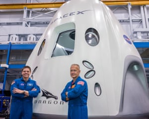 Astronauts Bob Behnken and Doug Hurley, stand beside the SpaceX Crew Dragon spacecraft