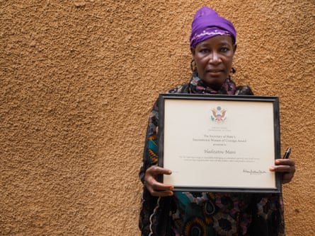 A woman holds a framed certificate