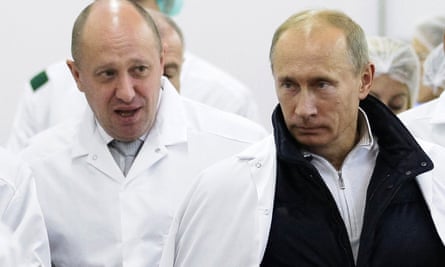 Yevgeny Prigozhin (left) showing Putin around his factory outside St Petersburg, which produced school meals, in 2010.