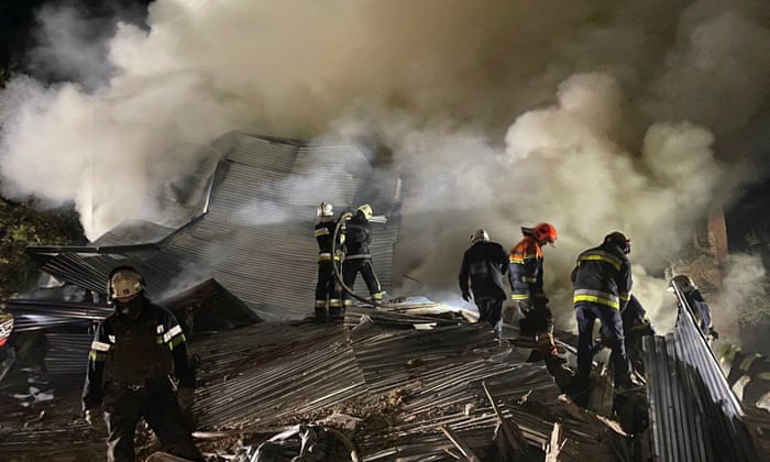Rescuers work at the site of a residential building destroyed by a Russian missile strike in Kharkiv.