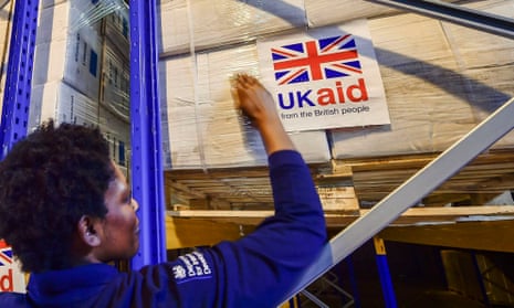 Logistics officer Beverley Sarpong placing UK Aid stickers onto cargo pallets containing British aid items destined for areas suffering humanitarian crisis at DFID's UK Disaster Response Operations Centre at Cotswold Airport, Kemble.