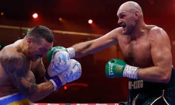 Fury lands a right hand on Usyk during their heavyweight title fight.