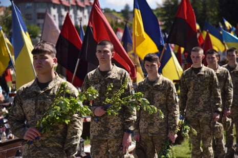Military cadets lay willow branches on Orthodox Palm Sunday at the graves of Ukrainian soldiers at the Lychakiv Cemetery in Lviv, Ukraine.