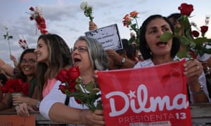 Women carrying flowers take part in a demonstration against the impeachment process of Dilma Rousseff