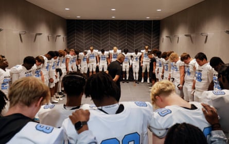 Cam Winston, the defensive backs coach for the NFL Academy, gathers all the players together in the showers of the home dressing room for a prayer just before kick off of their match against De La Salle Spartans.