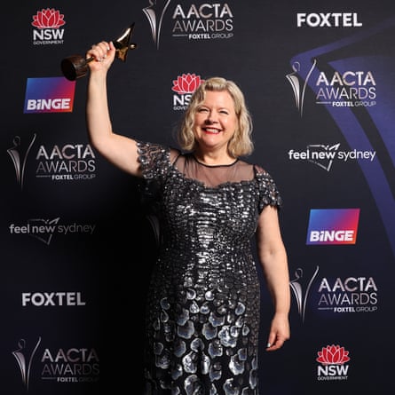 Mandy Walker holding up her award