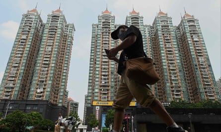 Man walks in front of buildings in China