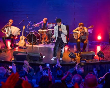 Luis Alberto Gómez, known locally as “JM,” sings with Los Cracks del Puerto during a performance at the SCD Hall in Mall Plaza Ñuñoa, Santiago, Chile. More than 200 people attended the concert. Gómez, a former market vendor, is one of the most recognised voices of Valparaíso’s traditional bohemian music scene. Santiago, Chile, on Friday, 5 June 2026. Tamara Merino for the Guardian.