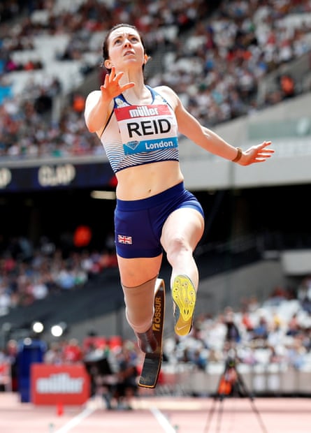 A Paralympian wearing a Team GB red and white uniform captured jumping in mid-air