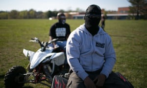 Masked to protect his identity, a WildOut Wheelie Boy waits for the pack to arrive