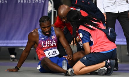 Noah Lyles receives medical treatment after the 200m final at Paris 2024.