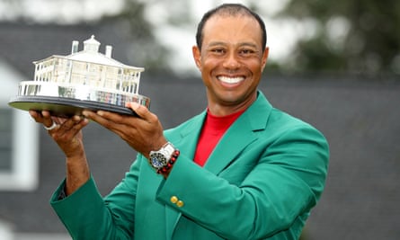 Woods poses in the Green Jacket after completing a glorious victory at Augusta National.