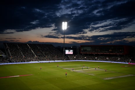 The sun sets over the Old Trafford stands on a perfect Manchester evening for cricket.