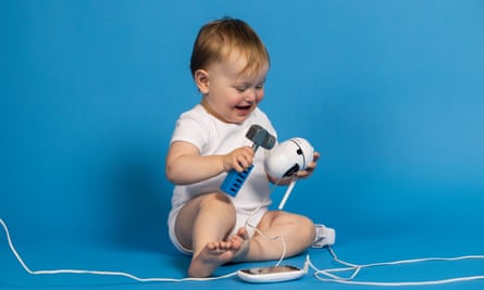 Baby with gadget and toy hammer