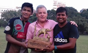 Tim Grandage poses with the club’s captain and coach with a special trophy.