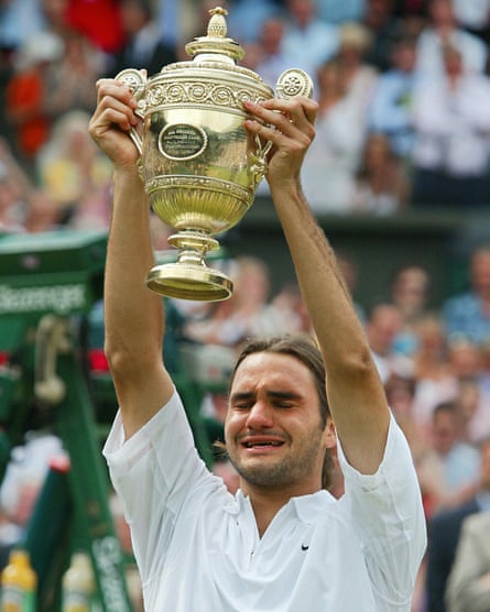 Roger Federer of Switzerland holds up the Wimbledon trophy in July 2003, after defeating Mark Philippoussis of Australia
