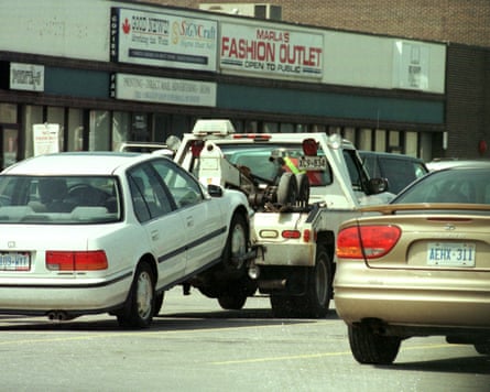 Car being towed on a street