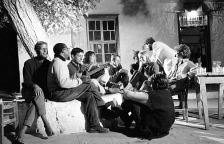 Leonard Cohen (holding the guitar) with Marianne (looking at him) and friends in Hydra, Greece, October 1960