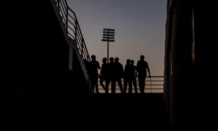 People watch a game at a ‘fan zone’ designed for migrant workers on the outskirts of Doha.