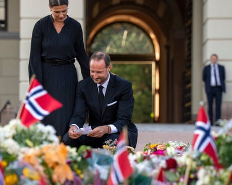 King Haakon VIII of Norway and Princess Maertha Louise of Norway look at the flowers and tributes that mourners have laid down in Oslo.