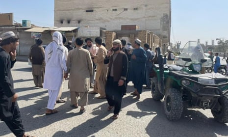 People gather at the scene of the blast in Kandahar