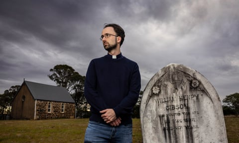 Minister of the Word, Daniel Mossfield stands by the cemetery near the small Uniting Church at Kialla