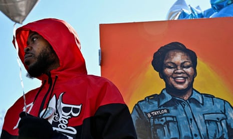 Kenneth Walker III, the boyfriend of Breonna Taylor, stands next to a painting of her at Jefferson Square Park in Louisville, Kentucky on 13 March 2022. 