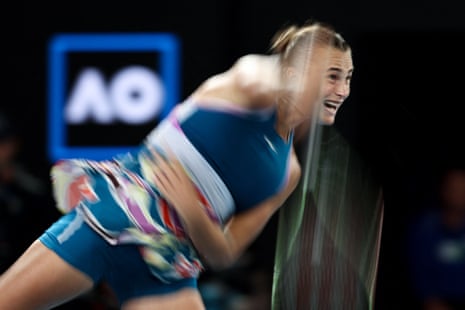 Aryna Sabalenka smashes a serve in the direction of Elena Rybakina.